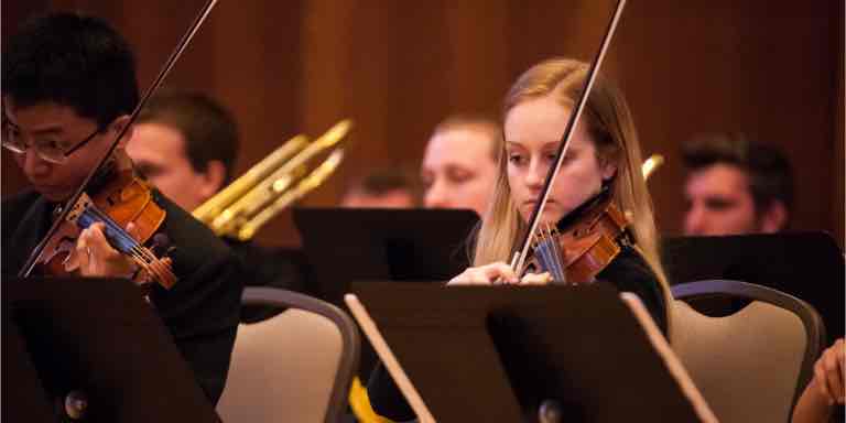 Violin section performing.