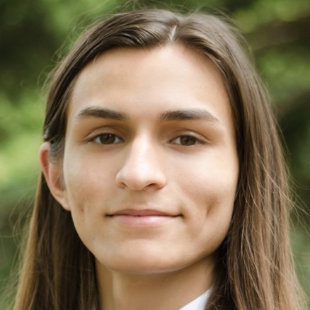 closeup of a person with long hair in front of a treeline