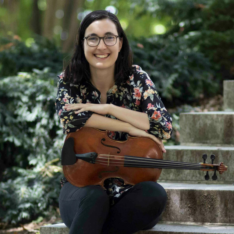 Woman smiling and holding a viola