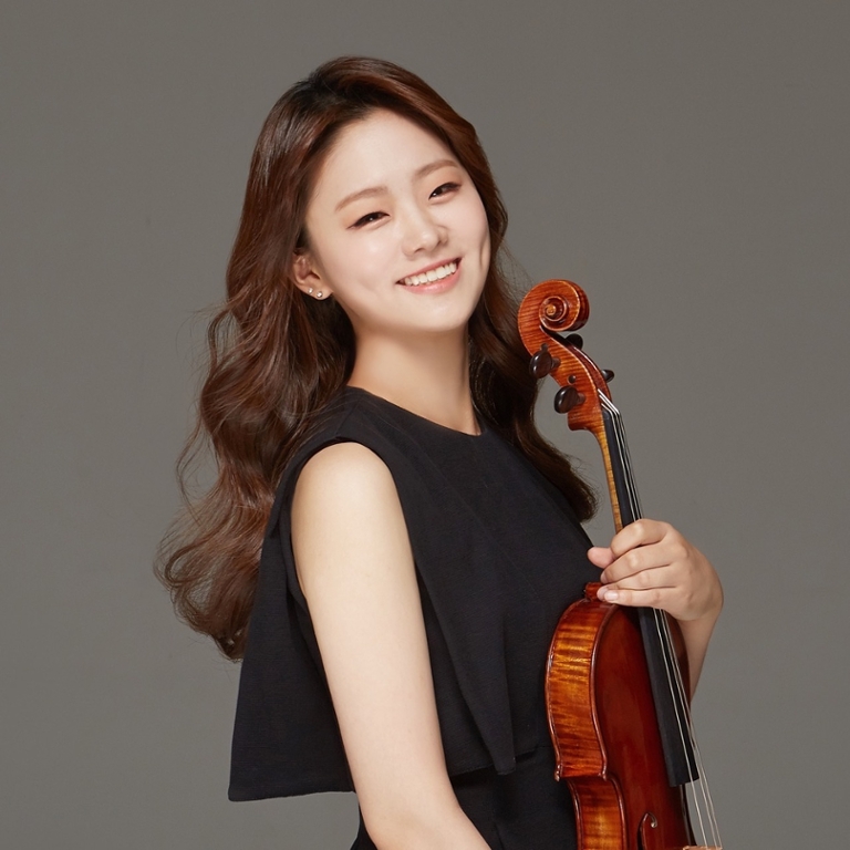 Woman smiling and holding a viola
