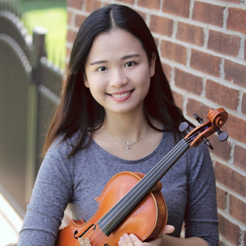 Woman smiling and holding a viola